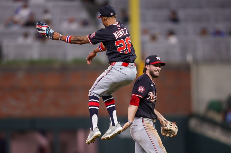 May 14, 2025; Atlanta, Georgia, USA; Washington Nationals shortstop Nasim Nunez (26) and right fielder Dylan Crews (3) celebrate after a victory over the Atlanta Braves at Truist Park. Mandatory Credit: Brett Davis-Imagn Images