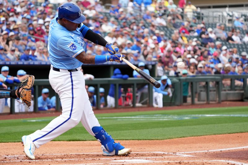 Mar 6, 2024; Surprise, Arizona, USA; Kansas City Royals catcher Salvador Perez (13) hits a solo home run against the Seattle Mariners during the first inning at Surprise Stadium. Mandatory Credit: Joe Camporeale-USA TODAY Sports