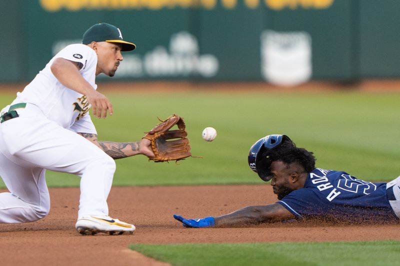 Jun 14, 2023; Oakland, California, USA;  Tampa Bay Rays left fielder Randy Arozarena (56) attempts to beat the ball during the fourth inning against the Oakland Athletics third baseman Jace Peterson (6) at Oakland-Alameda County Coliseum. Mandatory Credit: Stan Szeto-USA TODAY Sports