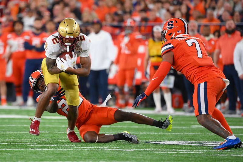 Nov 3, 2023; Syracuse, New York, USA; Boston College Eagles wide receiver Joseph Griffin Jr. (2) runs after a catch as Syracuse Orange defensive back Quan Peterson (22) and linebacker Stefon Thompson (7) defend during the first half at the JMA Wireless Dome. Mandatory Credit: Rich Barnes-USA TODAY Sports