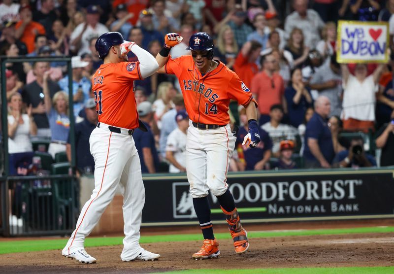 Jun 14, 2024; Houston, Texas, USA;  Houston Astros catcher Yainer Diaz (21) celebrates first baseman Mauricio Dubon (14) two-run home run against the Detroit Tigers in the sixth inning at Minute Maid Park. Mandatory Credit: Thomas Shea-USA TODAY Sports