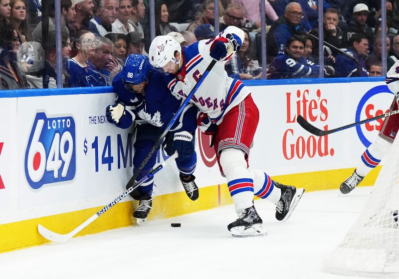 Oct 19, 2024; Toronto, Ontario, CAN; Toronto Maple Leafs right wing William Nylander (88) battles along the boards with New York Rangers defenseman Jacob Trouba (8) during the third period at Scotiabank Arena. Mandatory Credit: Nick Turchiaro-Imagn Images