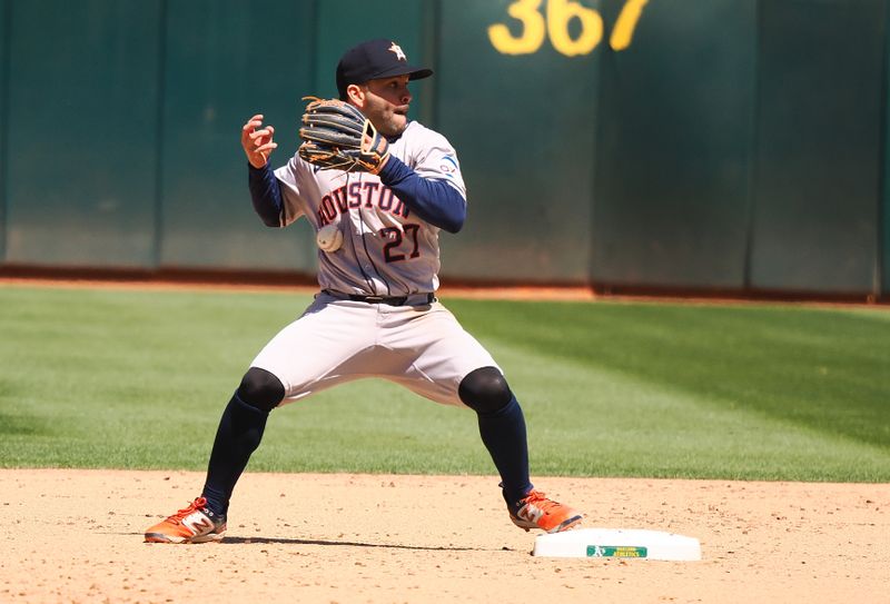 May 25, 2024; Oakland, California, USA; Houston Astros second baseman Jose Altuve (27) drops the ball as he attempts a double play Oakland Athletics during the eighth inning at Oakland-Alameda County Coliseum. Mandatory Credit: Kelley L Cox-USA TODAY Sports