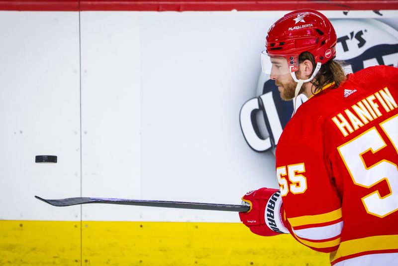 Mar 4, 2024; Calgary, Alberta, CAN; Calgary Flames defenseman Noah Hanifin (55) controls the puck during the warmup period against the Seattle Kraken at Scotiabank Saddledome. Mandatory Credit: Sergei Belski-USA TODAY Sports