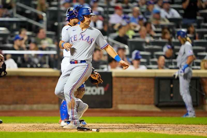 Aug 30, 2023; New York City, New York, USA;  Texas Rangers first baseman Nathaniel Lowe (30) scores a run on Texas Rangers catcher Jonah Heim (not pictured) RBI single against the New York Mets during the eighth inning at Citi Field. Mandatory Credit: Gregory Fisher-USA TODAY Sports