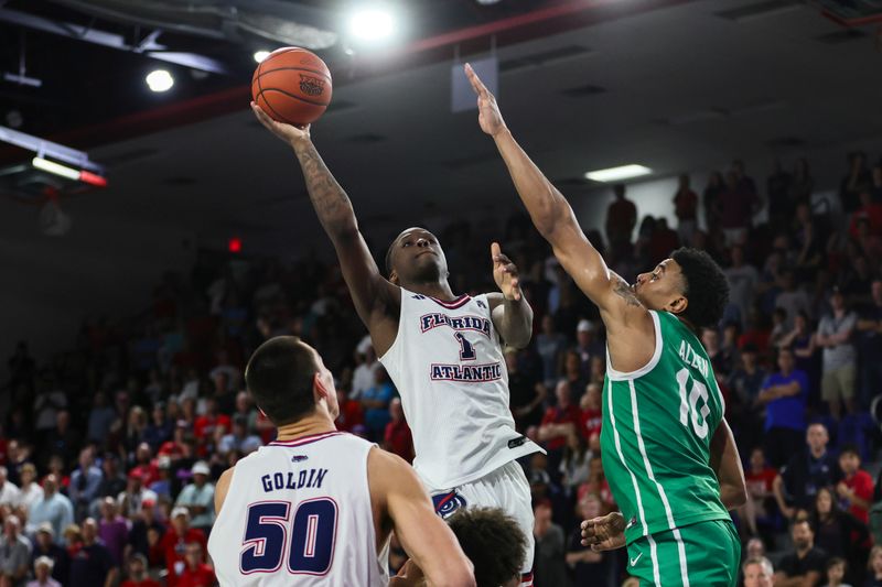 Jan 28, 2024; Boca Raton, Florida, USA; Florida Atlantic Owls guard Johnell Davis (1) shoots the basketball over North Texas Mean Green forward Robert Allen (10) during the second half at Eleanor R. Baldwin Arena. Mandatory Credit: Sam Navarro-USA TODAY Sports