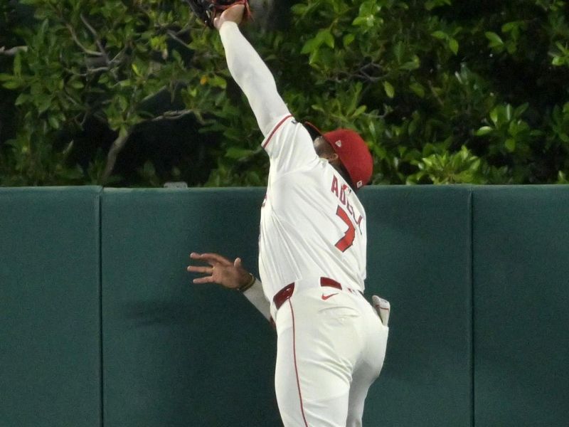 Jun 9, 2025; Anaheim, California, USA;   Los Angeles Angels center fielder Jo Adell (7) can’t make the catch at the wall on a pinch hit two run home run by Athletics center fielder JJ Bleday (33) at Angel Stadium. Mandatory Credit: Jayne Kamin-Oncea-Imagn Images