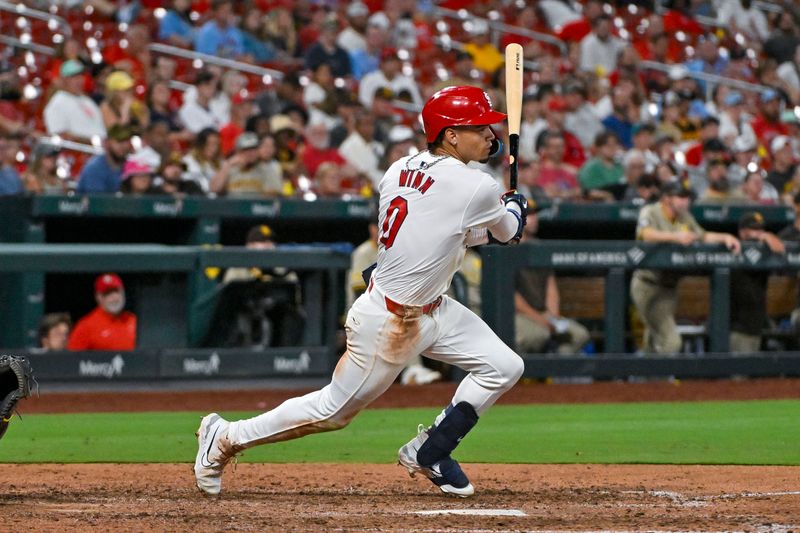 Aug 28, 2024; St. Louis, Missouri, USA;  St. Louis Cardinals shortstop Masyn Winn (0) hits a single against the San Diego Padres during the ninth inning at Busch Stadium. Mandatory Credit: Jeff Curry-USA TODAY Sports