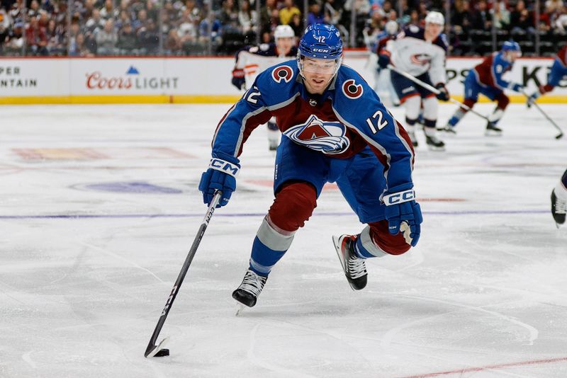 Mar 22, 2024; Denver, Colorado, USA; Colorado Avalanche right wing Brandon Duhaime (12) controls the puck in the second period against the Columbus Blue Jackets at Ball Arena. Mandatory Credit: Isaiah J. Downing-USA TODAY Sports