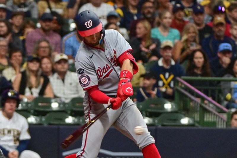 Sep 16, 2023; Milwaukee, Wisconsin, USA; Washington Nationals third baseman Carter Kieboom (8) drives in a run with a base hit in the sixth inning against the Milwaukee Brewers at American Family Field. Mandatory Credit: Benny Sieu-USA TODAY Sports