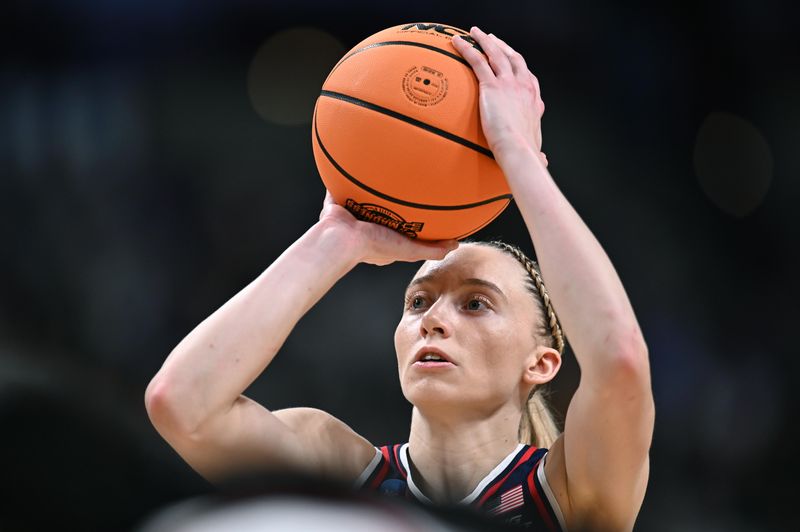 Mar 31, 2025; Spokane, WA, USA; UConn Huskies guard Paige Bueckers (5) shoots a free throw against the USC Trojans during the first half of a Elite 8 NCAA Tournament basketball game at Spokane Arena. Mandatory Credit: James Snook-Imagn Images