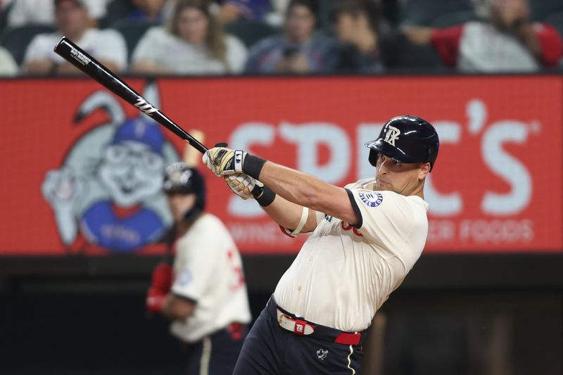 Aug 30, 2024; Arlington, Texas, USA; Texas Rangers first base Nathaniel Lowe (30) hits a solo home run in the second inning against the Oakland Athletics at Globe Life Field. Mandatory Credit: Tim Heitman-USA TODAY Sports