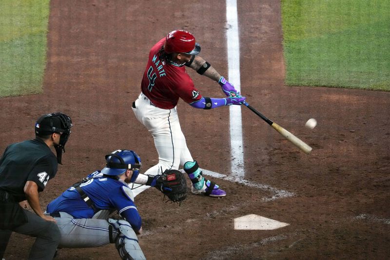 Jul 14, 2024; Phoenix, Arizona, USA; Arizona Diamondbacks second base Ketel Marte (4) hits a grand slam home run against the Toronto Blue Jays during the fifth inning at Chase Field. Mandatory Credit: Joe Camporeale-USA TODAY Sports