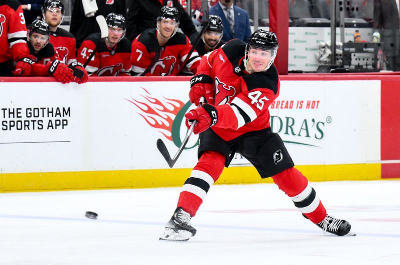 Dec 13, 2025; Newark, New Jersey, USA; New Jersey Devils defenseman Colton White (45) shoots against the Anaheim Ducks during the second period at Prudential Center. Mandatory Credit: John Jones-Imagn Images