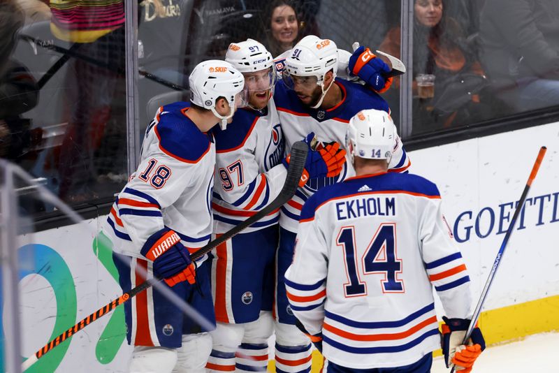 Feb 9, 2024; Anaheim, California, USA; Edmonton Oilers left wing Zach Hyman (18) celebrates with center Connor McDavid (97) and left wing Evander Kane (91) after scoring a goal against the Anaheim Ducks during the third period of a game at Honda Center. Mandatory Credit: Jessica Alcheh-USA TODAY Sports