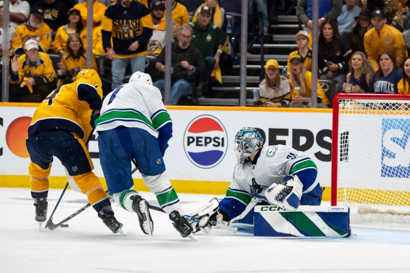 May 3, 2024; Nashville, Tennessee, USA; Vancouver Canucks goalkeeper Vancouver Canucks goalie Arturs Silovs (31) blocks the shot of Nashville Predators right wing Michael McCarron (47) during the first period in game six of the first round of the 2024 Stanley Cup Playoffs at Bridgestone Arena. Mandatory Credit: Steve Roberts-USA TODAY Sports