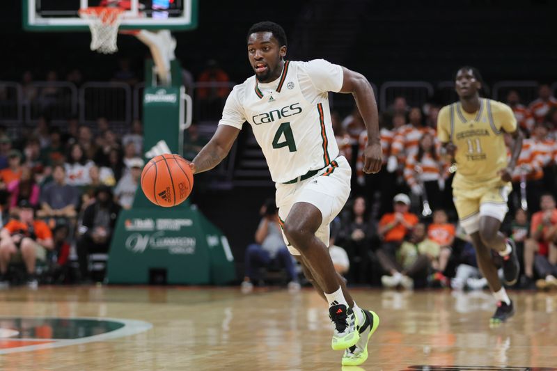 Feb 24, 2024; Coral Gables, Florida, USA; Miami Hurricanes guard Bensley Joseph (4) dribbles the basketball against the Georgia Tech Yellow Jackets during the second half at Watsco Center. Mandatory Credit: Sam Navarro-USA TODAY Sports