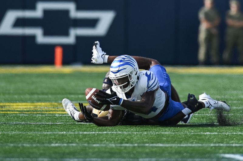 Sep 10, 2022; Annapolis, Maryland, USA;  Memphis Tigers wide receiver Javon Ivory (4) catches a pass as Navy Midshipmen cornerback Mbiti Williams Jr. (7) tackles during the first half at Navy-Marine Corps Memorial Stadium. Mandatory Credit: Tommy Gilligan-USA TODAY Sports