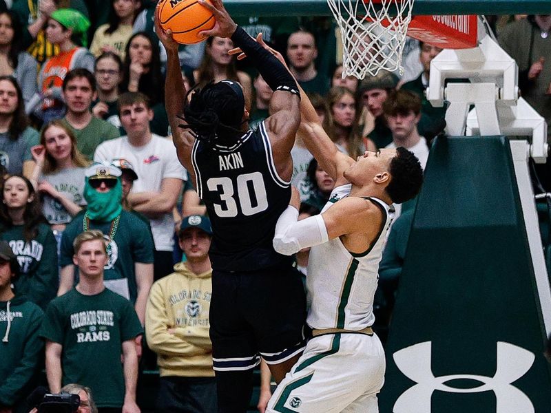 Feb 4, 2023; Fort Collins, Colorado, USA; Utah State Aggies forward Dan Akin (30) drives to the net against Colorado State Rams guard John Tonje (1) in the second half at Moby Arena. Mandatory Credit: Isaiah J. Downing-USA TODAY Sports