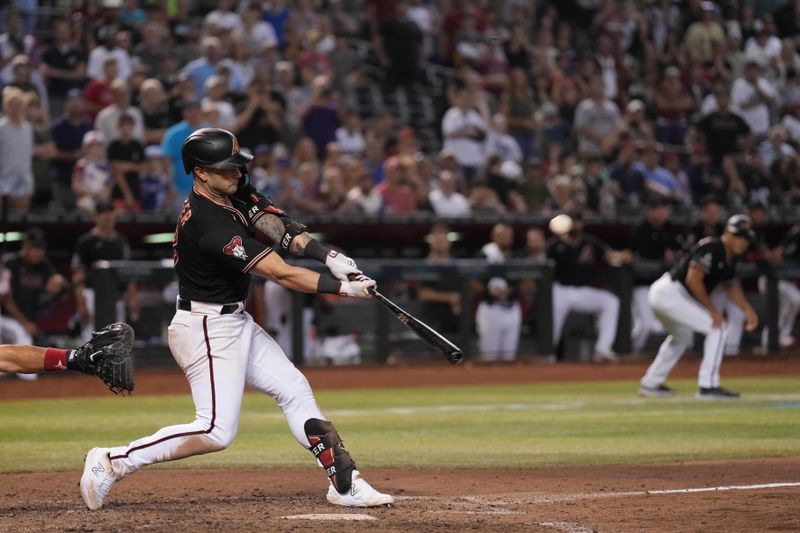 Aug 26, 2023; Phoenix, Arizona, USA; Arizona Diamondbacks first baseman Christian Walker (53) hits a sacrifice fly RBI against the Cincinnati Reds during the tenth inning at Chase Field. Mandatory Credit: Joe Camporeale-USA TODAY Sports