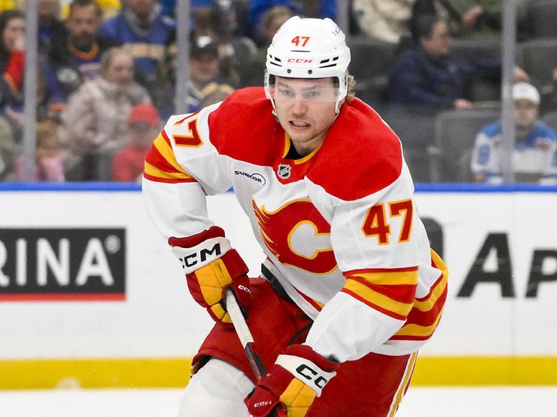 Nov 11, 2025; St. Louis, Missouri, USA; Calgary Flames center Connor Zary (47) controls the puck against the St. Louis Blues during the first period at Enterprise Center. Mandatory Credit: Jeff Curry-Imagn Images