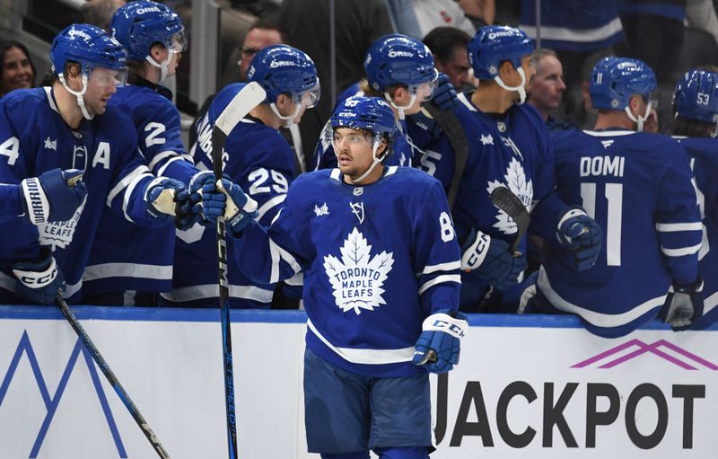 Sep 26, 2024; Toronto, Ontario, CAN;  Toronto Maple Leafs forward Nick Robertson (89) celebrates with team mates at the bench after scoring a goal against the Montreal Canadiens in the second period at Scotiabank Arena. Mandatory Credit: Dan Hamilton-Imagn Images