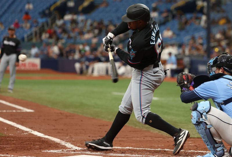 Jul 31, 2024; St. Petersburg, Florida, USA;  Miami Marlins shortstop Xavier Edwards (63) hits a sacrifice fly to drive in a run against the Tampa Bay Rays during the third inning at Tropicana Field. Mandatory Credit: Kim Klement Neitzel-USA TODAY Sports