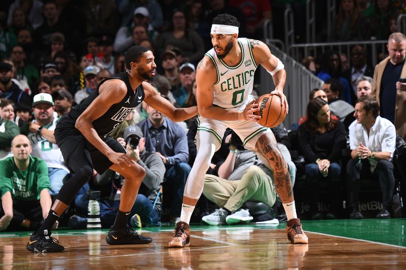 BOSTON, MA - FEBRUARY 14: Jayson Tatum #0 of the Boston Celtics handles the ball during the game as Mikal Bridges #1 of the Brooklyn Nets plays defense on February 14, 2024 at the TD Garden in Boston, Massachusetts. NOTE TO USER: User expressly acknowledges and agrees that, by downloading and or using this photograph, User is consenting to the terms and conditions of the Getty Images License Agreement. Mandatory Copyright Notice: Copyright 2024 NBAE  (Photo by Brian Babineau/NBAE via Getty Images)