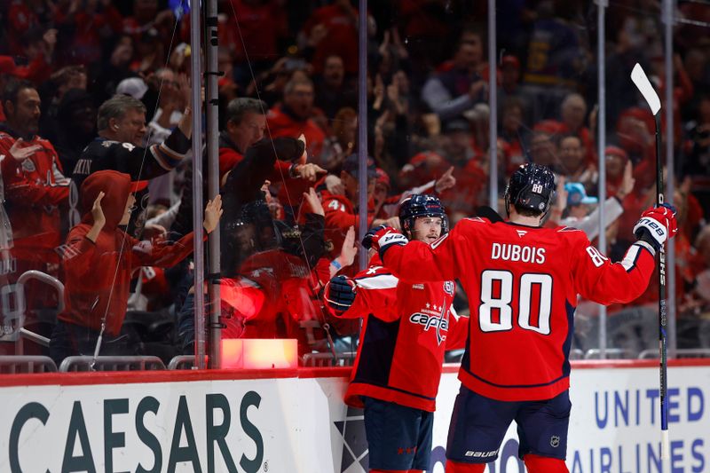 Oct 31, 2024; Washington, District of Columbia, USA; Washington Capitals center Connor McMichael (24) celebrates with Capitals left wing Pierre-Luc Dubois (80) after scoring a goal against the Montreal Canadiens in the third period at Capital One Arena. Mandatory Credit: Geoff Burke-Imagn Images