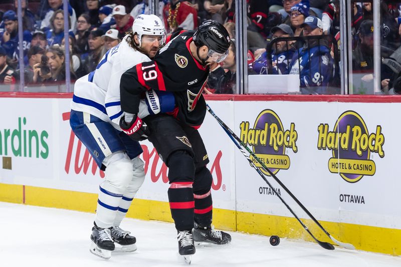 Jan 25, 2025; Ottawa, Ontario, CAN; Toronto Maple Leafs defenseman Christopher Tanev (8) battles with Ottawa Senators right wing Drake Batherson (19) in the first period at the Canadian Tire Centre. Mandatory Credit: Marc DesRosiers-Imagn Images