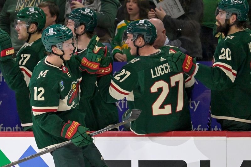 Jan 25, 2024; Saint Paul, Minnesota, USA; Minnesota Wild defenseman Brock Faber (7) celebrates his assist on a power play goal by forward Matt Boldy (12) with forward Brandon Duhaime (21) and forward Jacob Lucchini (27) during the third period at Xcel Energy Center. Mandatory Credit: Nick Wosika-USA TODAY Sports