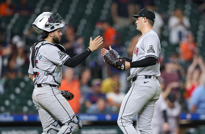 Sep 8, 2024; Houston, Texas, USA; Arizona Diamondbacks catcher Adrian Del Castillo (25) and relief pitcher Paul Sewald (38) celebrate after the game against the Houston Astros at Minute Maid Park. Mandatory Credit: Troy Taormina-Imagn Images