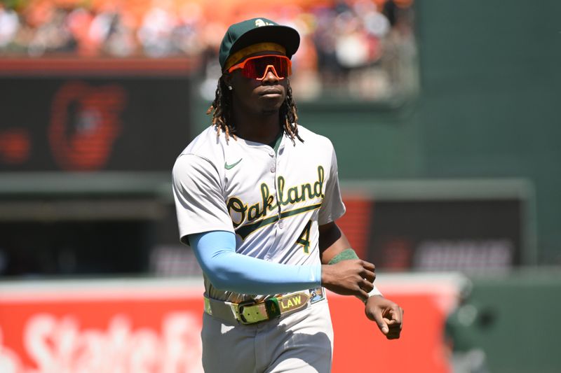 Apr 28, 2024; Baltimore, Maryland, USA;  Oakland Athletics right fielder Lawrence Butler (4) warms up on the field prior to the game between the Baltimore Orioles and the Oakland Athletics at Oriole Park at Camden Yards. Mandatory Credit: James A. Pittman-USA TODAY Sports