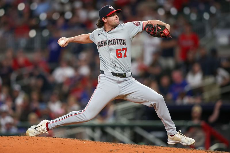 May 30, 2024; Atlanta, Georgia, USA; Washington Nationals relief pitcher Kyle Finnegan (67) throws against the Atlanta Braves in the ninth inning at Truist Park. Mandatory Credit: Brett Davis-USA TODAY Sports