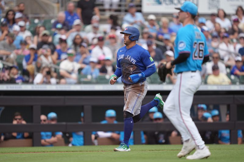 Mar 16, 2026; Jupiter, Florida, USA;  Toronto Blue Jays designated hitter George Springer (4) advances home to score a run on a wild pitch by Miami Marlins pitcher Janson Junk (26) in the third inning at Roger Dean Chevrolet Stadium. Mandatory Credit: Jim Rassol-Imagn Images