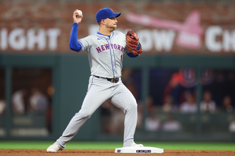 Sep 24, 2024; Atlanta, Georgia, USA; New York Mets second baseman Jose Iglesias (11) throws to first against the Atlanta Braves in the first inning at Truist Park. Mandatory Credit: Brett Davis-Imagn Images