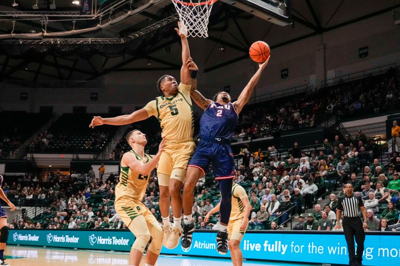 Jan 6, 2024; Charlotte, North Carolina, USA; Charlotte 49ers guard Isaiah Folkes (5) blocks the shot by Florida Atlantic Owls guard Nicholas Boyd (2) during the second half at Dale F. Halton Arena. Mandatory Credit: Jim Dedmon-USA TODAY Sports