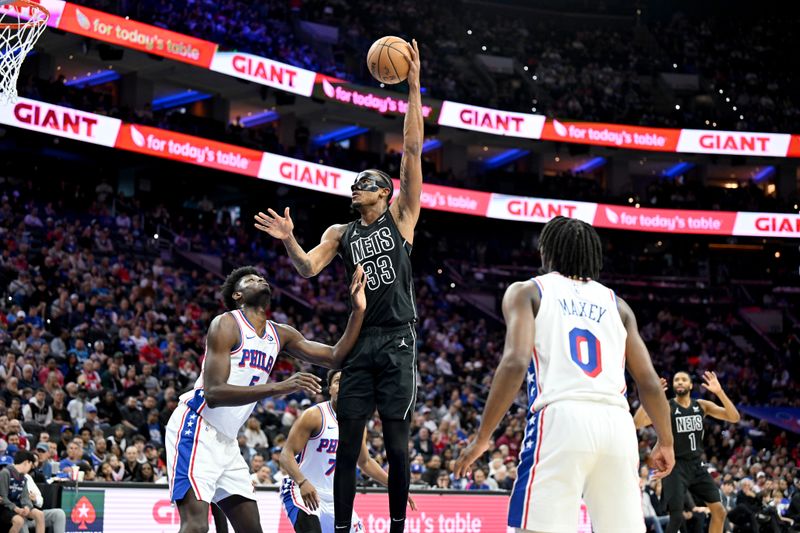 PHILADELPHIA, PENNSYLVANIA - APRIL 14: Nic Claxton #33 of the Brooklyn Nets shoots the ball in the third quarter against Mo Bamba #5 of the Philadelphia 76ers at the Wells Fargo Center on April 14, 2024 in Philadelphia, Pennsylvania.  NOTE TO USER: User expressly acknowledges and agrees that, by downloading and or using this photograph, User is consenting to the terms and conditions of the Getty Images License Agreement. (Photo by Greg Fiume/Getty Images)