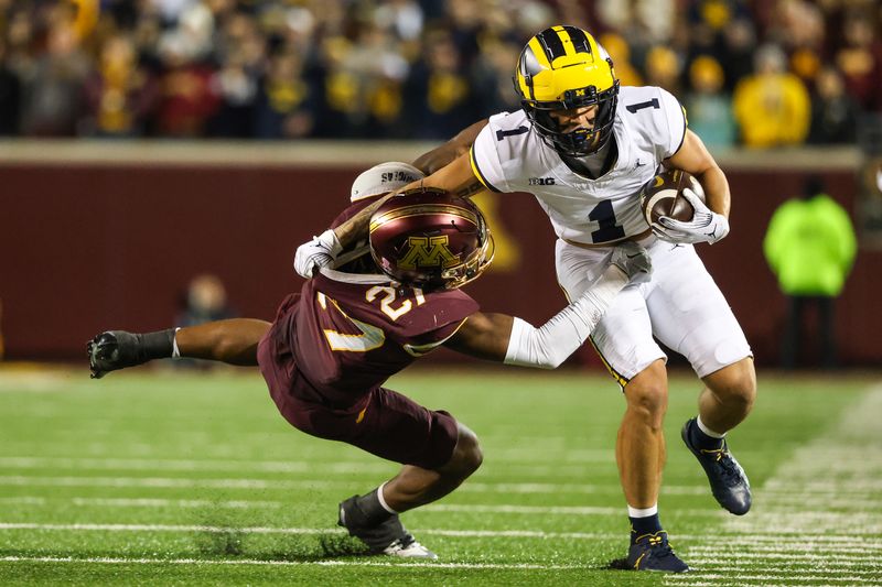 Oct 7, 2023; Minneapolis, Minnesota, USA; Michigan Wolverines wide receiver Roman Wilson (1) runs while Minnesota Golden Gophers defensive back Tyler Nubin (27) defends during the third quarter at Huntington Bank Stadium. Mandatory Credit: Matt Krohn-USA TODAY Sports