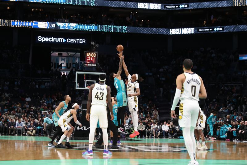 CHARLOTTE, NC - FEBRUARY 4: Nick Richards #4 of the Charlotte Hornets and Myles Turner #33 of the Indiana Pacers go up for a jump ball on February 4, 2024 at Spectrum Center in Charlotte, North Carolina. NOTE TO USER: User expressly acknowledges and agrees that, by downloading and or using this photograph, User is consenting to the terms and conditions of the Getty Images License Agreement.  Mandatory Copyright Notice:  Copyright 2024 NBAE (Photo by Brock Williams-Smith/NBAE via Getty Images)
