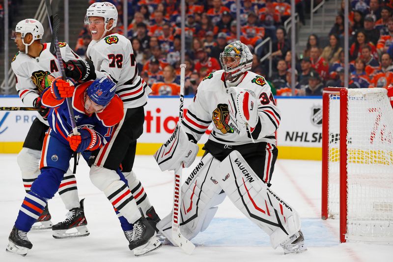 Oct 12, 2024; Edmonton, Alberta, CAN; Edmonton Oilers forward Zach Hyman (18) battles with Chicago Blackhawks defensemen Alex Vlasic (72) in front of goaltender Petr Mrazek (34) during the first period at Rogers Place. Mandatory Credit: Perry Nelson-Imagn Images