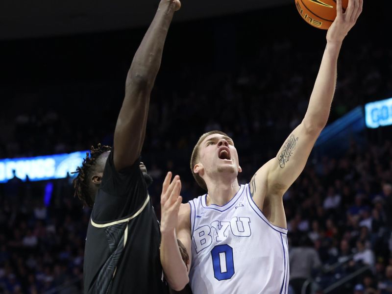 Feb 13, 2024; Provo, Utah, USA; Brigham Young Cougars forward Noah Waterman (0) goes to the basket against Central Florida Knights forward Ibrahima Diallo (11) during the second half at Marriott Center. Mandatory Credit: Rob Gray-USA TODAY Sports