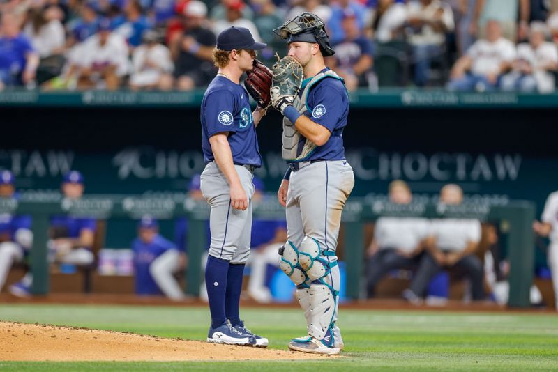 Sep 21, 2024; Arlington, Texas, USA; Seattle Mariners pitcher Troy Taylor (59) and catcher Cal Raleigh (29) talk prior to the sixth inning against the Texas Rangers at Globe Life Field. Mandatory Credit: Andrew Dieb-Imagn Images