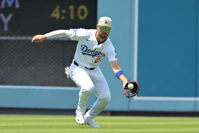 May 18, 2025; Los Angeles, California, USA; Los Angeles Dodgers outfielder Michael Conforto (23) fields an RBI single by Los Angeles Angels catcher Travis d'Arnaud (not pictured) in the third inning at Dodger Stadium. Mandatory Credit: Jayne Kamin-Oncea-Imagn Images