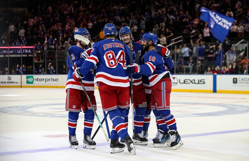 Sep 24, 2024; New York, New York, USA; New York Rangers center Adam Edstrom (84) celebrates game-winner goal with defenseman Jacob Trouba (8) and center Vincent Trocheck (16) during the third period against the New York Islanders at Madison Square Garden. Mandatory Credit: Danny Wild-Imagn Images