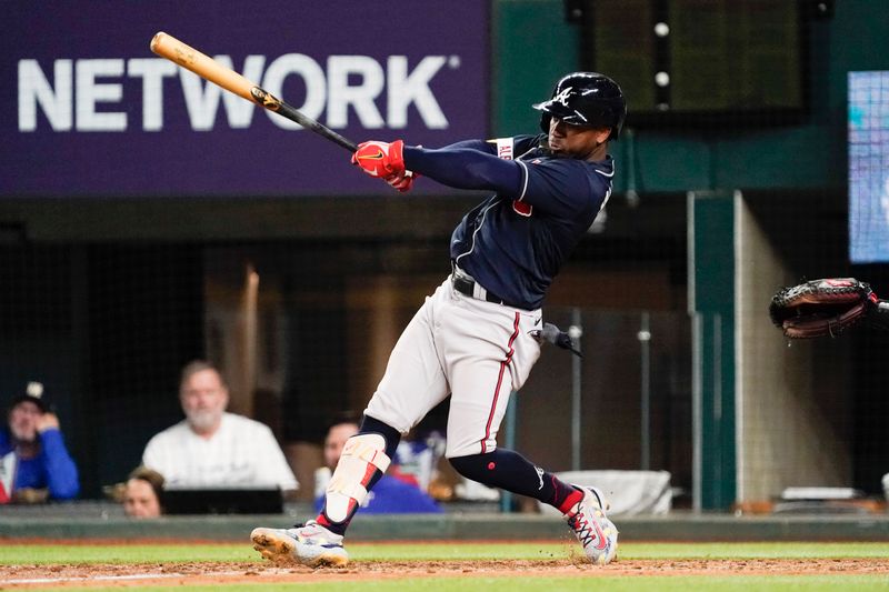 May 17, 2023; Arlington, Texas, USA; Atlanta Braves second baseman Ozzie Albies (1) hits an an RBI single during the eighth inning against the Texas Rangers at Globe Life Field. Mandatory Credit: Raymond Carlin III-USA TODAY Sports