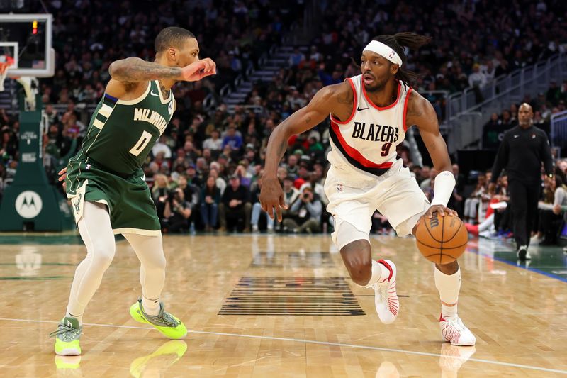 MILWAUKEE, WISCONSIN - NOVEMBER 26: Jerami Grant #9 of the Portland Trail Blazers is defended by Damian Lillard #0 of the Milwaukee Bucks during a game at Fiserv Forum on November 26, 2023 in Milwaukee, Wisconsin. NOTE TO USER: User expressly acknowledges and agrees that, by downloading and or using this photograph, User is consenting to the terms and conditions of the Getty Images License Agreement. (Photo by Stacy Revere/Getty Images)