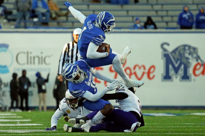 Nov 19, 2022; Memphis, Tennessee, USA; Memphis Tigers quarterback Ryan Glover (1) hurdles a North Alabama Lions defender during the second half at Simmons Bank Liberty Stadium. Mandatory Credit: Petre Thomas-USA TODAY Sports