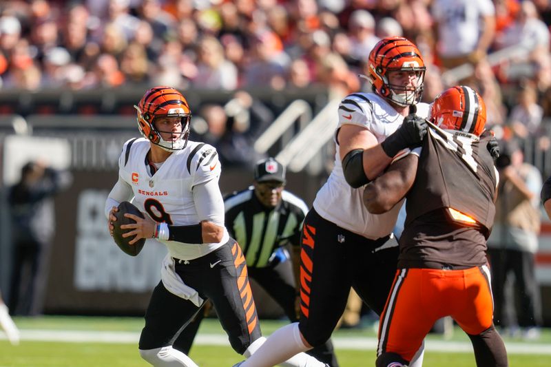 Cincinnati Bengals quarterback Joe Burrow (9) drops back to pass in the first half of an NFL football game against the Cleveland Browns, Sunday, Oct. 20, 2024, in Cleveland. (AP Photo/Sue Ogrocki)