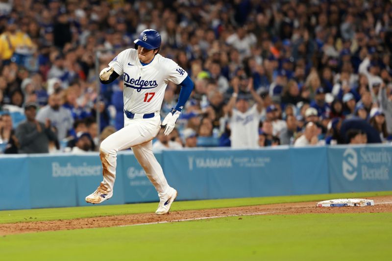 Apr 19, 2024; Los Angeles, California, USA;  Los Angeles Dodgers designated hitter Shohei Ohtani (17) runs around third base to score on RBI single by outfielder Teoscar Hernandez (37, not pictured) during the fourth inning at Dodger Stadium. Mandatory Credit: Kiyoshi Mio-USA TODAY Sports